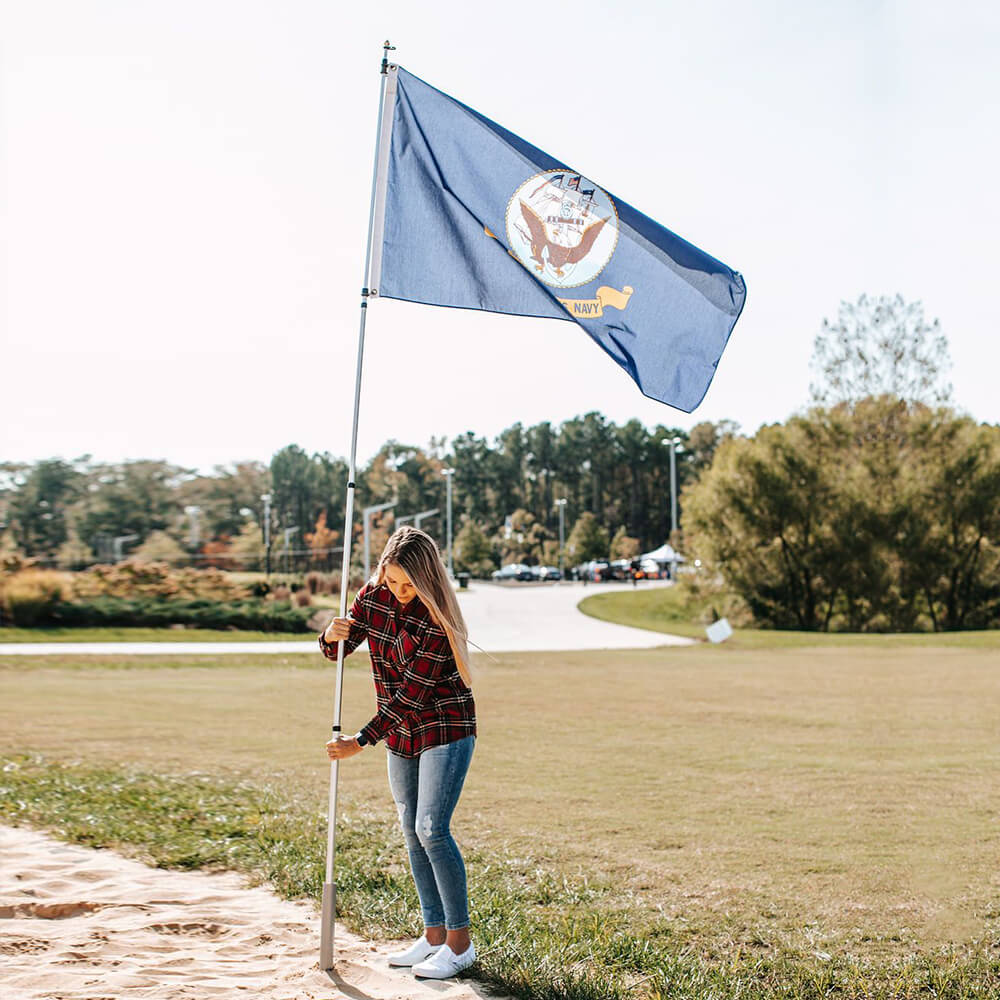 woman adding aluminum telescoping flagpole to ground mount